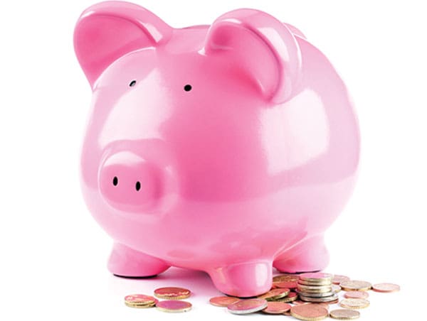 Pink piggy bank with coins below it