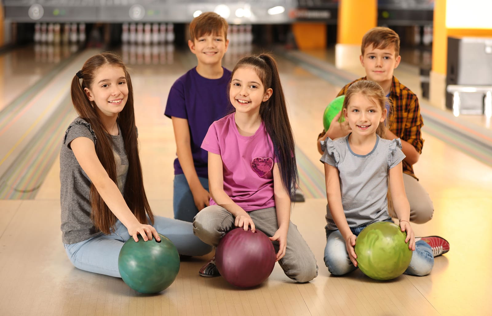 Happy Children With Balls In Bowling Club